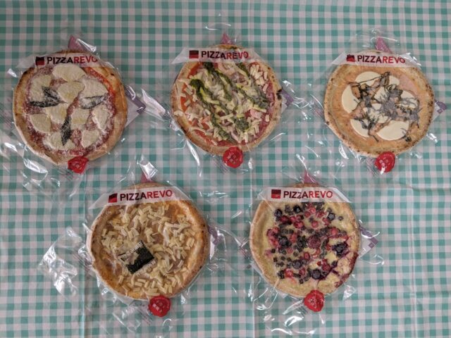 ピザ屋「ピザレボ(PIZZAREVO)博多阪急店」の冷凍ピザ5種類をテーブルに置いている写真
